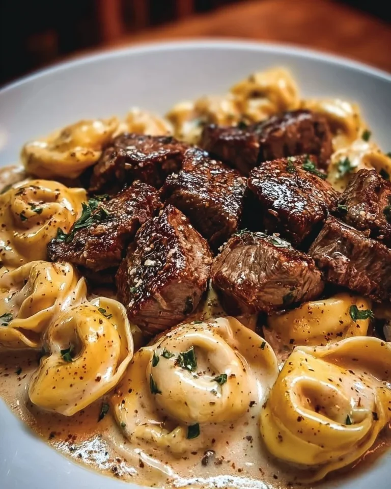 Cracked garlic steak tortellini in creamy sauce served on a plate