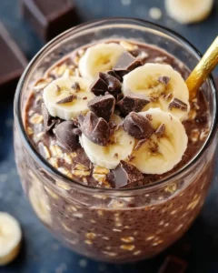Delicious creamy chocolate banana overnight oats in a bowl topped with banana slices