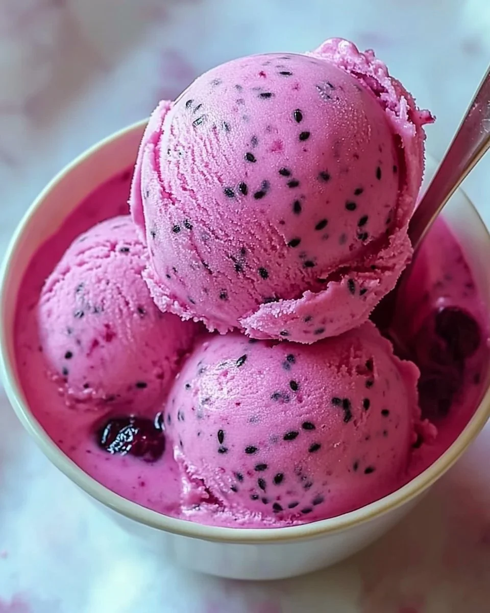 Delicious dragon fruit ice cream in a bowl topped with fresh fruit