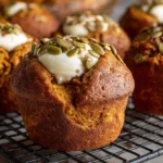 Freshly baked Starbucks pumpkin muffin recipe with cream cheese centers on a cooling rack.